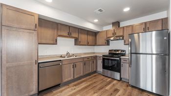 A kitchen with wooden cabinets and stainless steel appliances.
